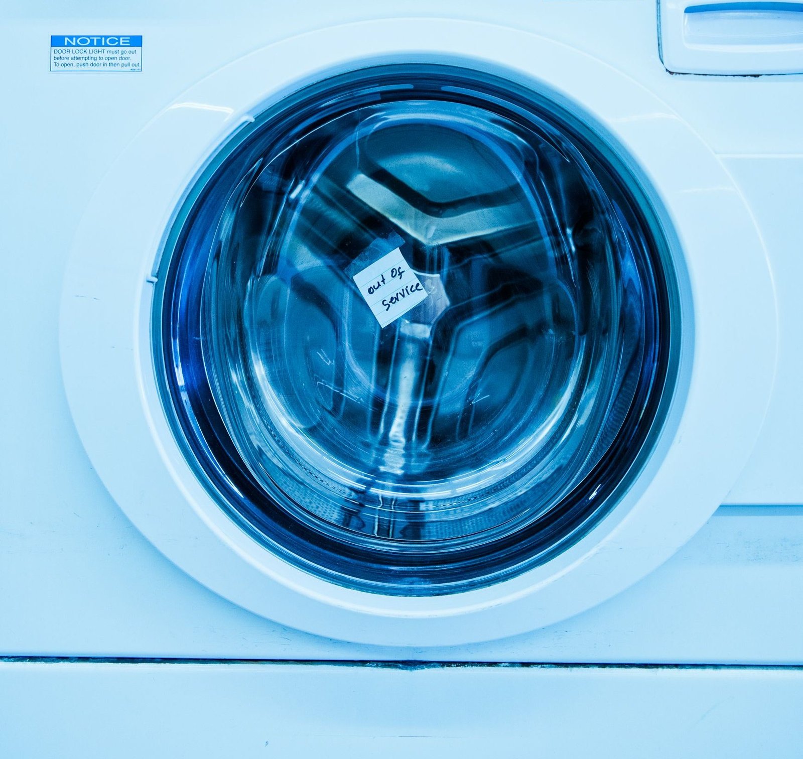The drum of a front load washing machine behind its glass door