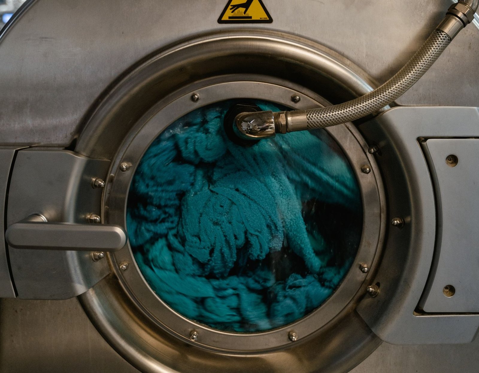 A stainless steel washing machine drum mid-cycle