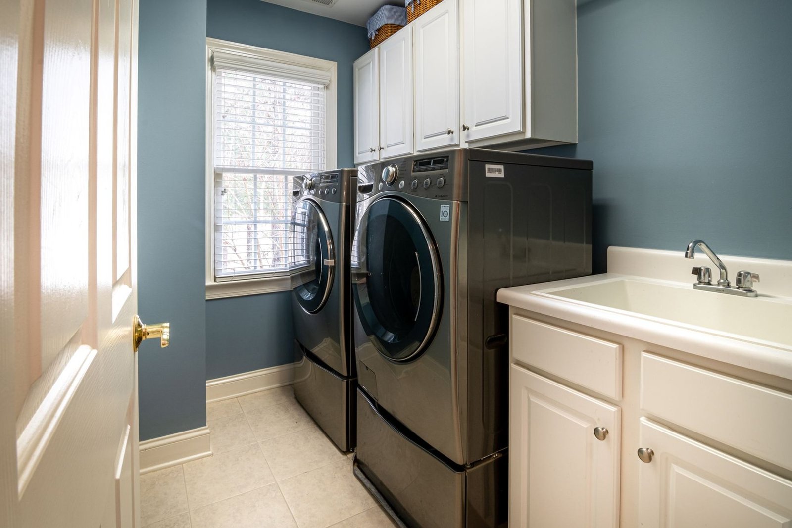 A front load washer and dryer installed in a home laundry room
