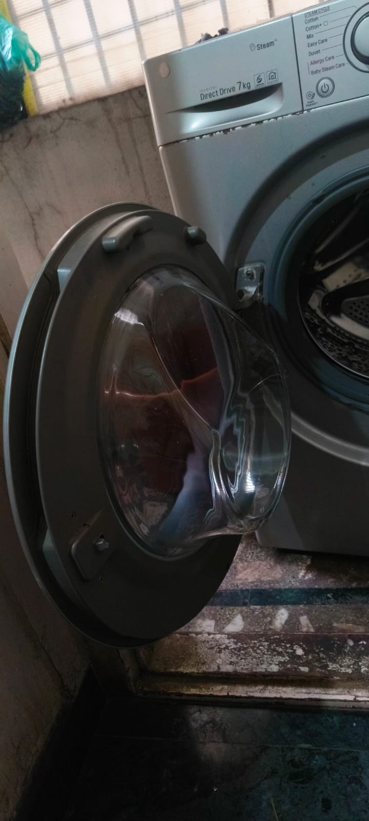 A door assembly with its glass bowl come away from the frame, taken off for replacement.